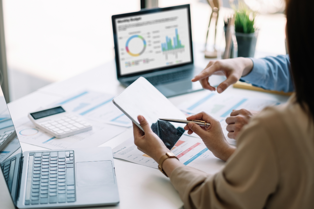 A modern flat-style illustration of a marketing dashboard displaying bar graphs, line charts, and pie charts representing digital marketing performance metrics.